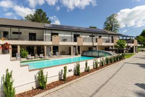 an exterior view of a house with a swimming pool at Balaton Flow Residence in Fonyód
