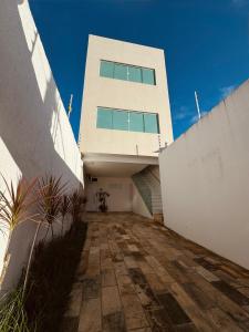 a white building with a walkway in front of it at Nox Temporada Flat 201 com AR, a 5 Min da Feira de Caruaru in Caruaru