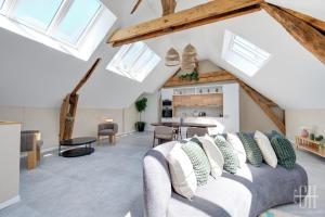 a living room with a couch and a table at Gigi - Duplex - 4V - Chateau d amboise in Amboise