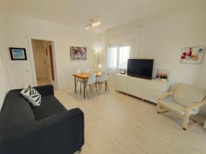 a living room with a couch and a table at Apartamento Celine in Pineda de Mar +11 photos