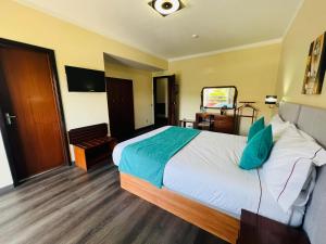a hotel room with a large bed and a television at Hotel Colmeia in Monte Real
