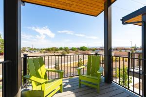 two chairs on a balcony with a view at Brand NEW Townhome! Luxury AND Convenience - NO EXTRA FEES! in Grand Junction
