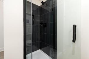 a bathroom with a shower with a glass door at Brand NEW Townhome! Luxury AND Convenience - NO EXTRA FEES! in Grand Junction +12 photos