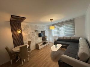 a living room with a couch and a table at Apartman Sueno Foca in Foča