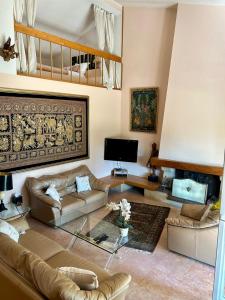 a living room with a couch and a table at Villa les Faou-Anis in Le Castellet