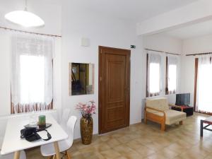 a living room with a table and a door at Villa Dima in Paleo Tsifliki