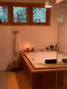 a large bathroom with a tub and a shower at Yellow House Santa Clara in Bocaina de Minas +25 photos