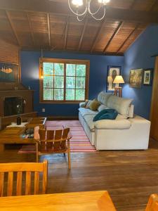a living room with a couch and a table at Yellow House Santa Clara in Bocaina de Minas