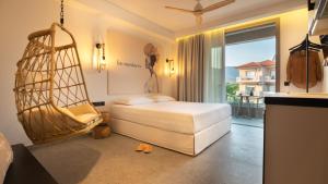 a bedroom with a bed and a swing at Be Modern Aparts & Studios in Limenaria