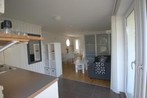 a kitchen and a living room with a table at Villa South Beach in Karlskrona