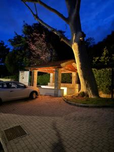 a car parked in front of a building with a tree at Luna Home in Arona