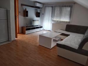 a living room with a couch and a coffee table at Apartman Bojan in Prnjavor