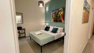 a bedroom with a bed with pillows on it at Chez D'Ossuna - Cultura e Relax -10 minuti dalla Cattedrale in Palermo