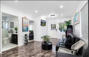 a living room with a couch and a table at LUXURY VILLA Estate Oasis in Downey