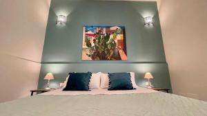 a bedroom with a large bed with two pillows at Chez D'Ossuna - Cultura e Relax -10 minuti dalla Cattedrale in Palermo