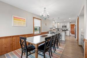 a kitchen and dining room with a table and chairs at Endless Summer in Sanderling