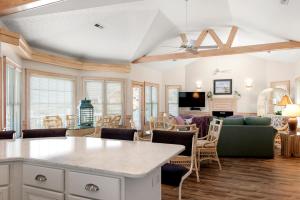 a living room with a couch and a table at Fergusons Flagship in Nags Head