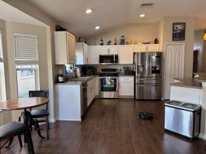 a kitchen with stainless steel appliances and a table at Ruskin FL 2 bdrm 1 bath suite Host & Cat share common areas in Ruskin