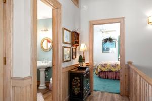 a bathroom with a sink and a bedroom with a bed at Fergusons Flagship in Nags Head