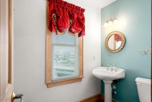 a bathroom with a sink and a window at Fergusons Flagship in Nags Head