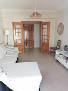 a bedroom with two beds and a table and a chair at Casa Vila Rosa - T1 Altura Beach in Altura