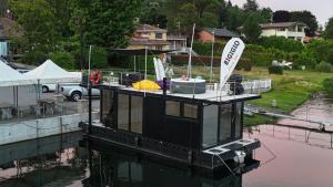 a house boat docked at a dock in the water at DIAMOND Bigigio House Boat in Lisanza