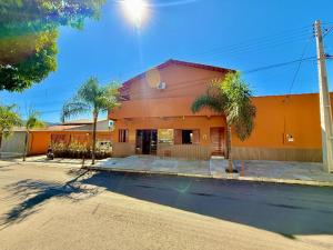an orange building with a street in front of it at Pousada Estrela Guia in Pirenópolis
