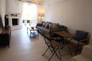 a living room with a couch and a table at Bright & Bloom maisonette in Hanioti