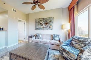 a living room with a couch and a ceiling fan at Luau I 6710 in Destin