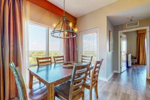 a dining room with a table and chairs and a window at Luau I 6710 in Destin +37 photos