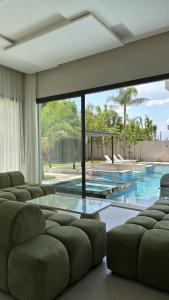 a living room with a couch and a swimming pool at La Villa K Marrakech jacuzzi chauffé in Marrakech