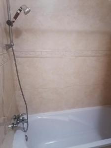 a shower in a bathroom with a white bath tub at Casa Vila Rosa - T1 Altura Beach in Altura +28 photos