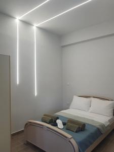 a white room with a bed with two pillows at Galazio suites 3 in Salamís