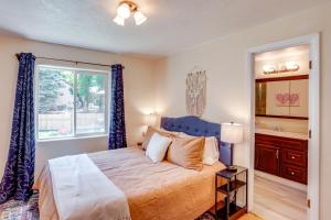 a bedroom with a bed with a blue headboard and a window at Hike On-Site Mountain-View Hideaway in Durango in Durango