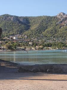 a beach with people swimming in the water at Galazio suites 3 in Salamís +9 photos