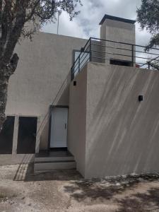 a building with a white door and a ramp at Mi lugar en el mundo in Cortaderas