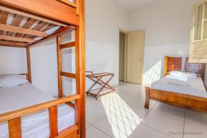 a room with two bunk beds and a balcony at Hostel Mineirinho in Belo Horizonte