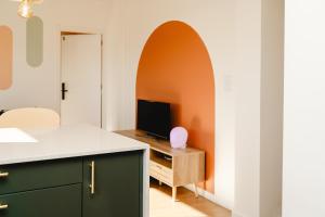 an archway in a living room with a television at Chocolate House in Viana do Castelo