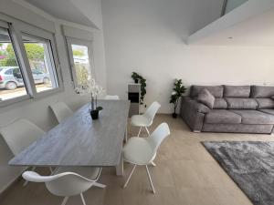 a living room with a table and chairs and a couch at Villa Ohana - A Murcia Holiday Rentals Property in Roldán