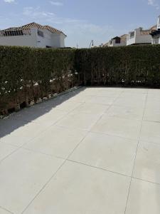 a concrete walkway in front of a hedge at Villa Ohana - A Murcia Holiday Rentals Property in Roldán