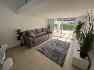 a living room with a couch and a rug at Villa Ohana - A Murcia Holiday Rentals Property in Roldán +1 photo