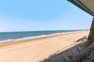a view of the beach from a window at Golden Strand Unit C3 in Kill Devil Hills