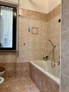 a bathroom with a tub and a toilet at Nuvola House in Mandello del Lario +13 photos
