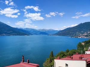 a view of a lake with mountains in the background at Nuvola House in Mandello del Lario