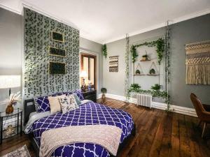 a bedroom with a bed with a blue and white blanket at Walk to Trinity Hartford 2BR Gem Barry Square in Hartford