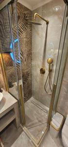 a shower stall in a bathroom with a toilet at Charlie Chaplin luxury apartments in Perea