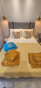a bedroom with a large bed with two pillows at Charlie Chaplin luxury apartments in Perea