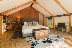 a bedroom with a bed and a desk and a chair at The Fields of Michigan in South Haven