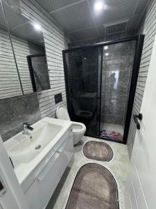 a bathroom with a toilet and a sink and a shower at Relax 1 Lüks villa in Kemer