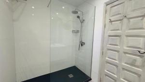 a shower with a glass door in a bathroom at Casa Charlotte El Cotillo in El Cotillo +14 photos